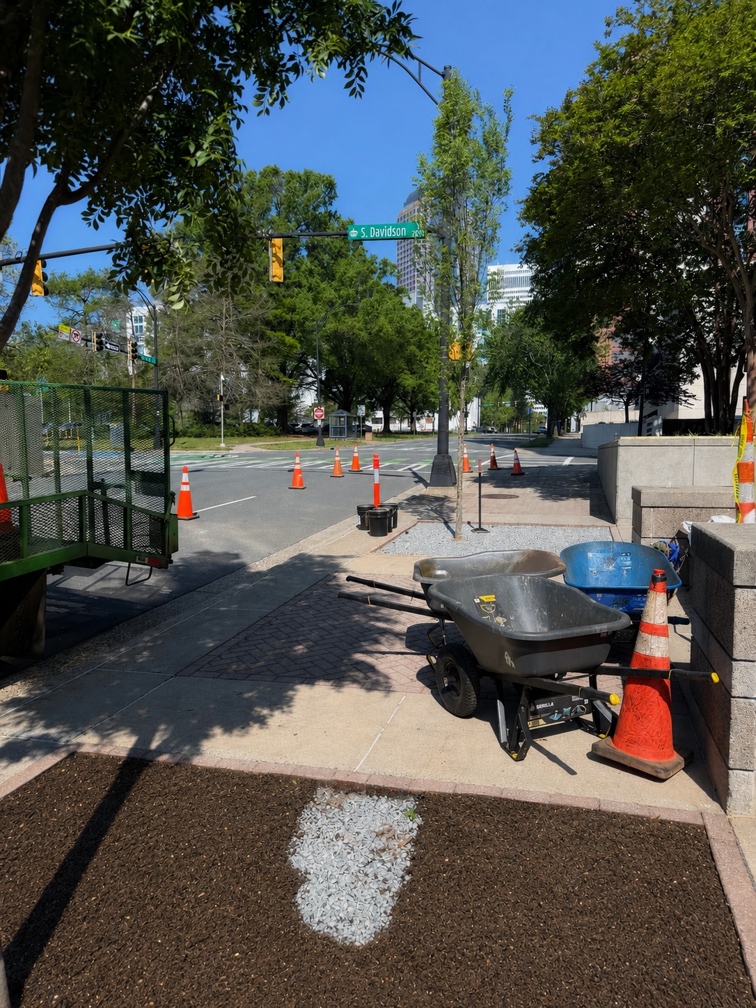 Roundtree streetscape installation work with wheelbarrows and planting area in downtown Charlotte